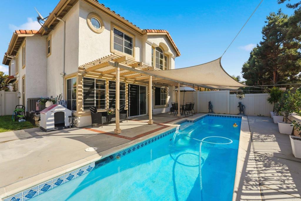 2505 Whispering Palms Loop Chula Vista, CA 91915 - Photo 31 of 45 a view of a house with backyard porch and sitting area