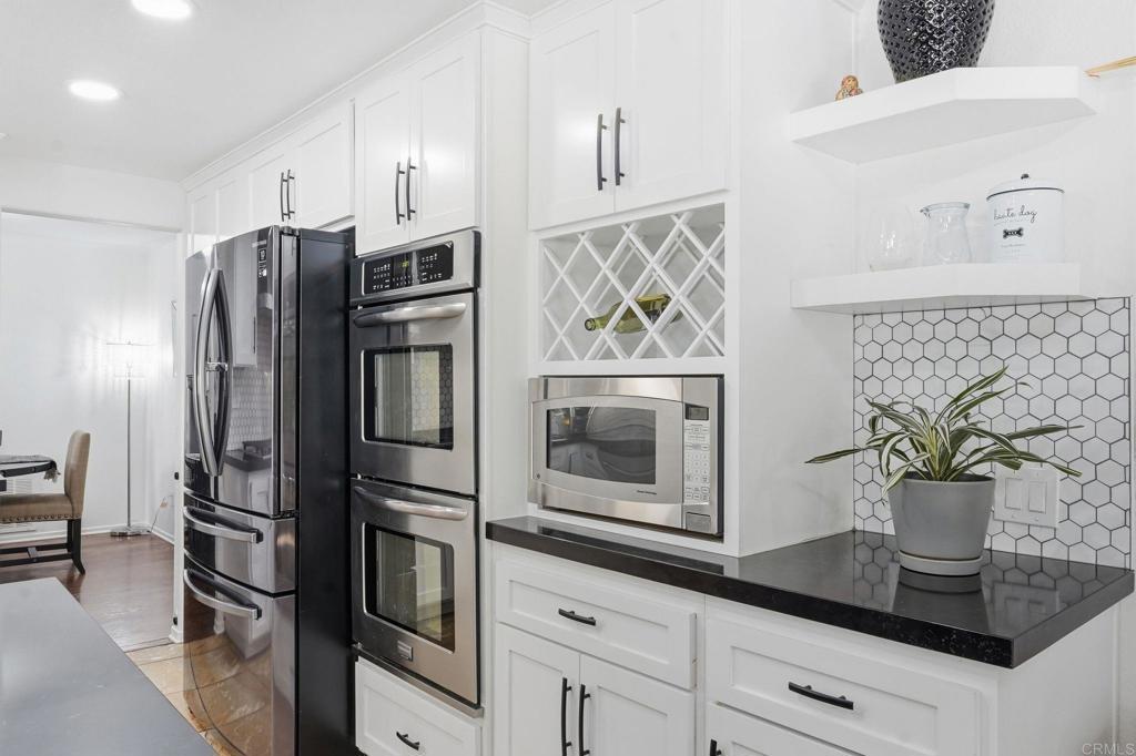 2505 Whispering Palms Loop Chula Vista, CA 91915 - Photo 8 of 45 a kitchen with stainless steel appliances granite countertop a refrigerator and a stove