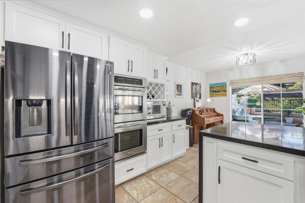 2505 Whispering Palms Loop Chula Vista, CA 91915 - Photo 10 of 45 a kitchen with granite countertop a refrigerator stove and sink