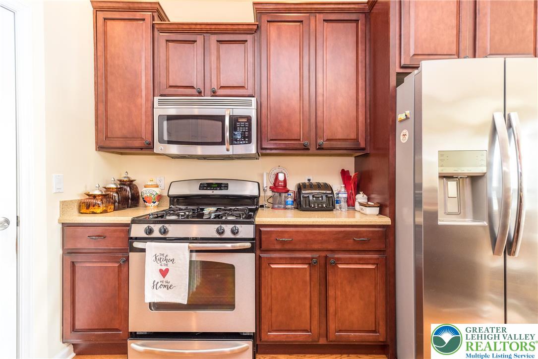 3540 Lenape Lane Emmaus, PA 18049 - Photo 7 of 29 Kitchen has some 42 inch cabinets, solid surface countertops, gas range and microwave