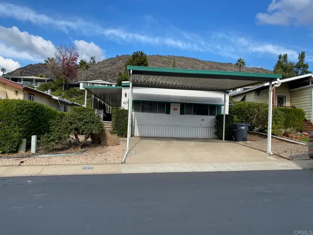 a view of a patio with a table and chairs with wooden fence