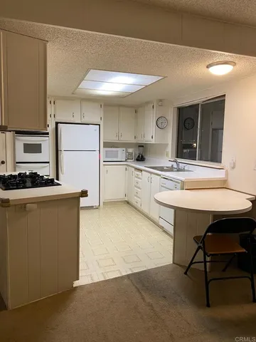 a kitchen with a sink cabinets and window