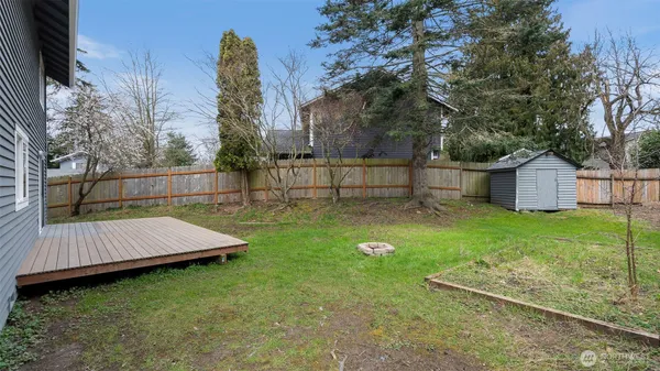 a view of a backyard with wooden fence