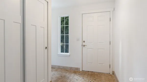 an empty room with windows and closet