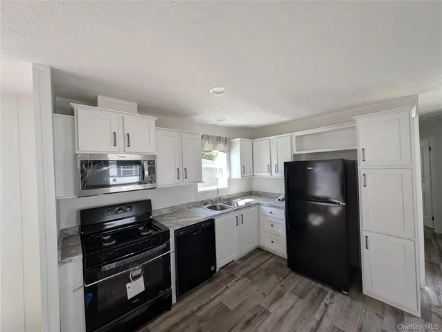 a kitchen with a refrigerator stove and sink