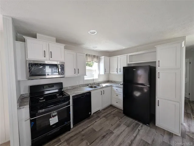 a kitchen with a refrigerator and a stove top oven