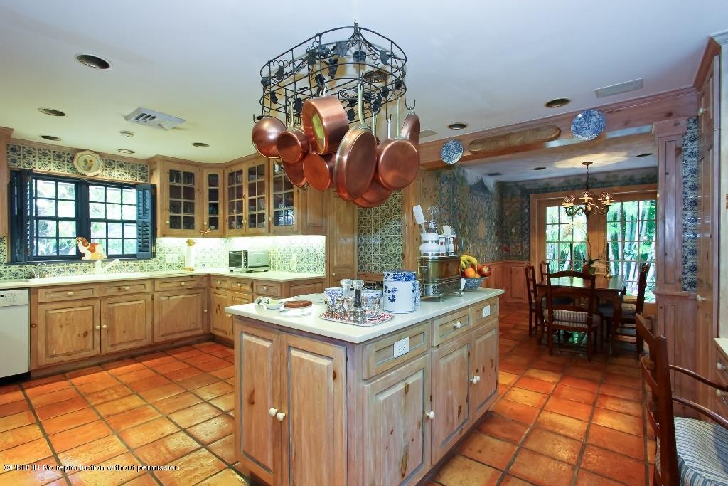 275 Monterey Road Palm Beach, FL 33480 - Photo 5 of 9 a kitchen with a sink stove and cabinets