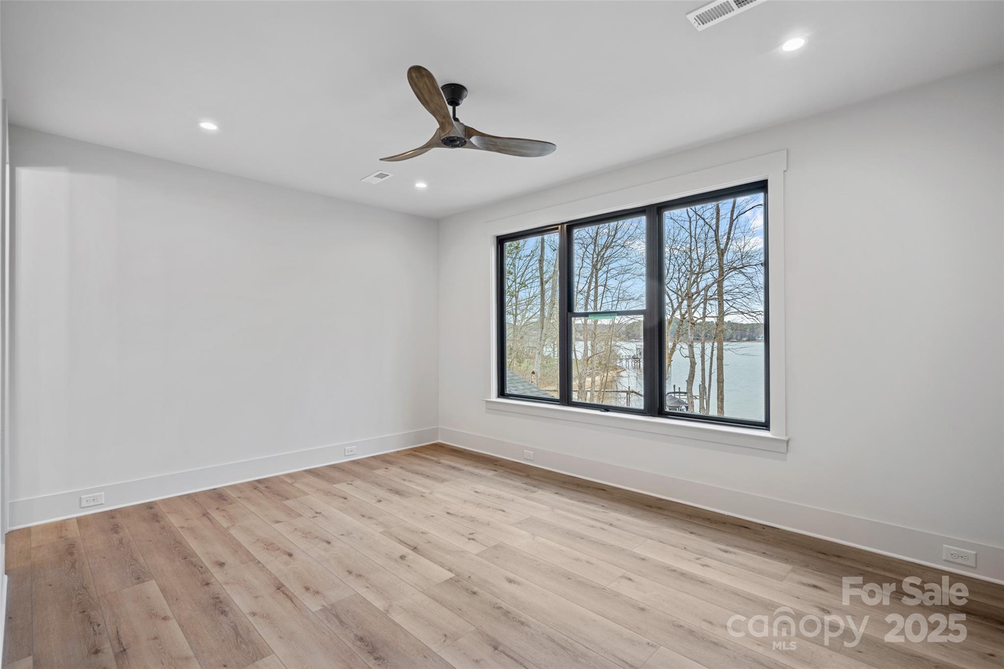 515 Kemp Road Mooresville, NC 28117 - Photo 14 of 24 a view of an empty room with a window and wooden floor