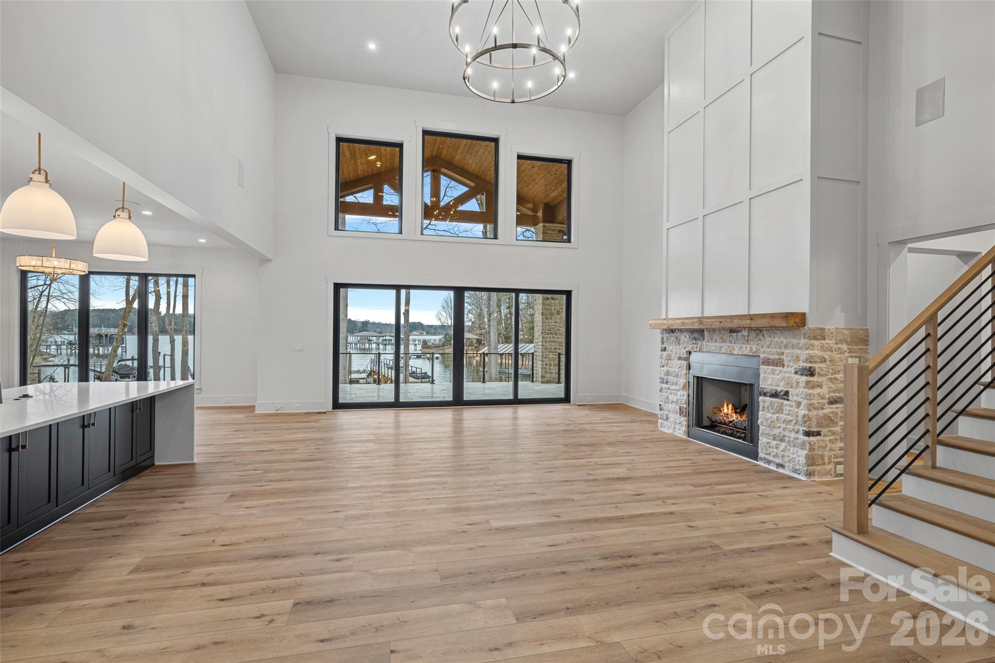 515 Kemp Road Mooresville, NC 28117 - Photo 16 of 34 a big room with wooden floor fireplace and windows
