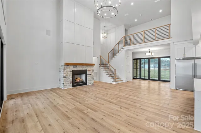 a view of empty room with wooden floor and fireplace