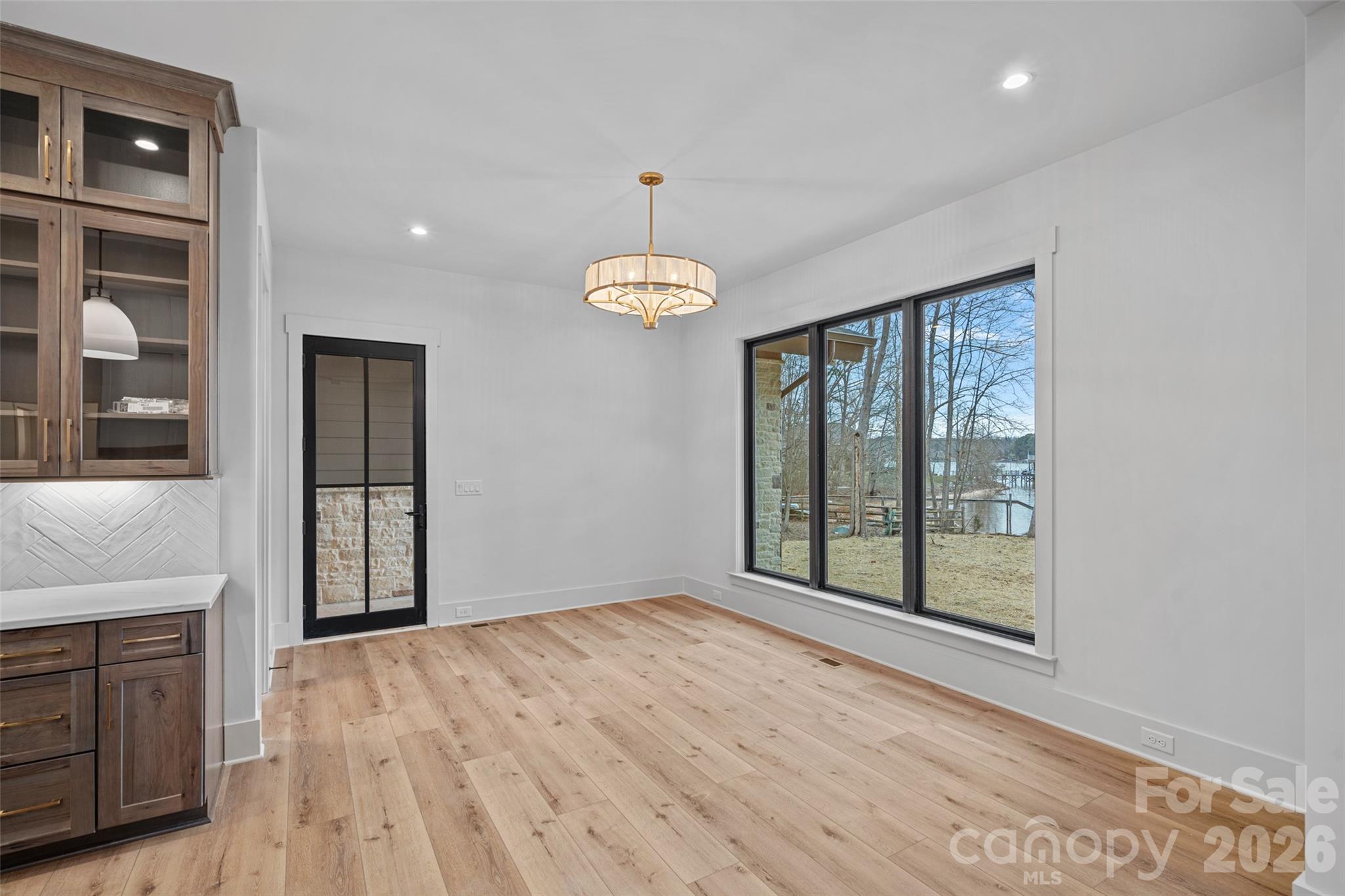 515 Kemp Road Mooresville, NC 28117 - Photo 18 of 34 a view of an empty room with a window and wooden floor
