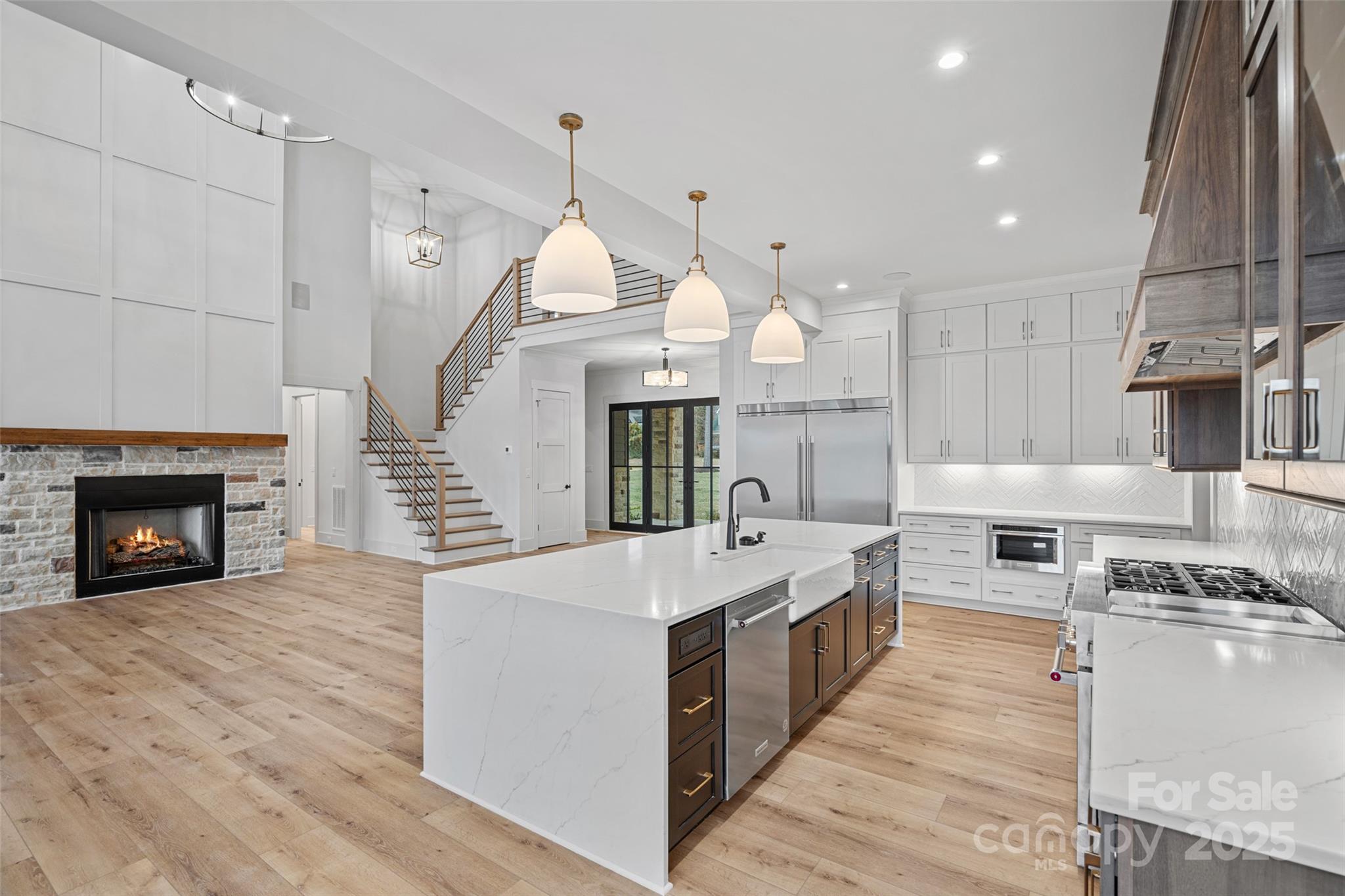 515 Kemp Road Mooresville, NC 28117 - Photo 2 of 24 a large kitchen with stainless steel appliances kitchen island granite countertop a stove and a view of living room