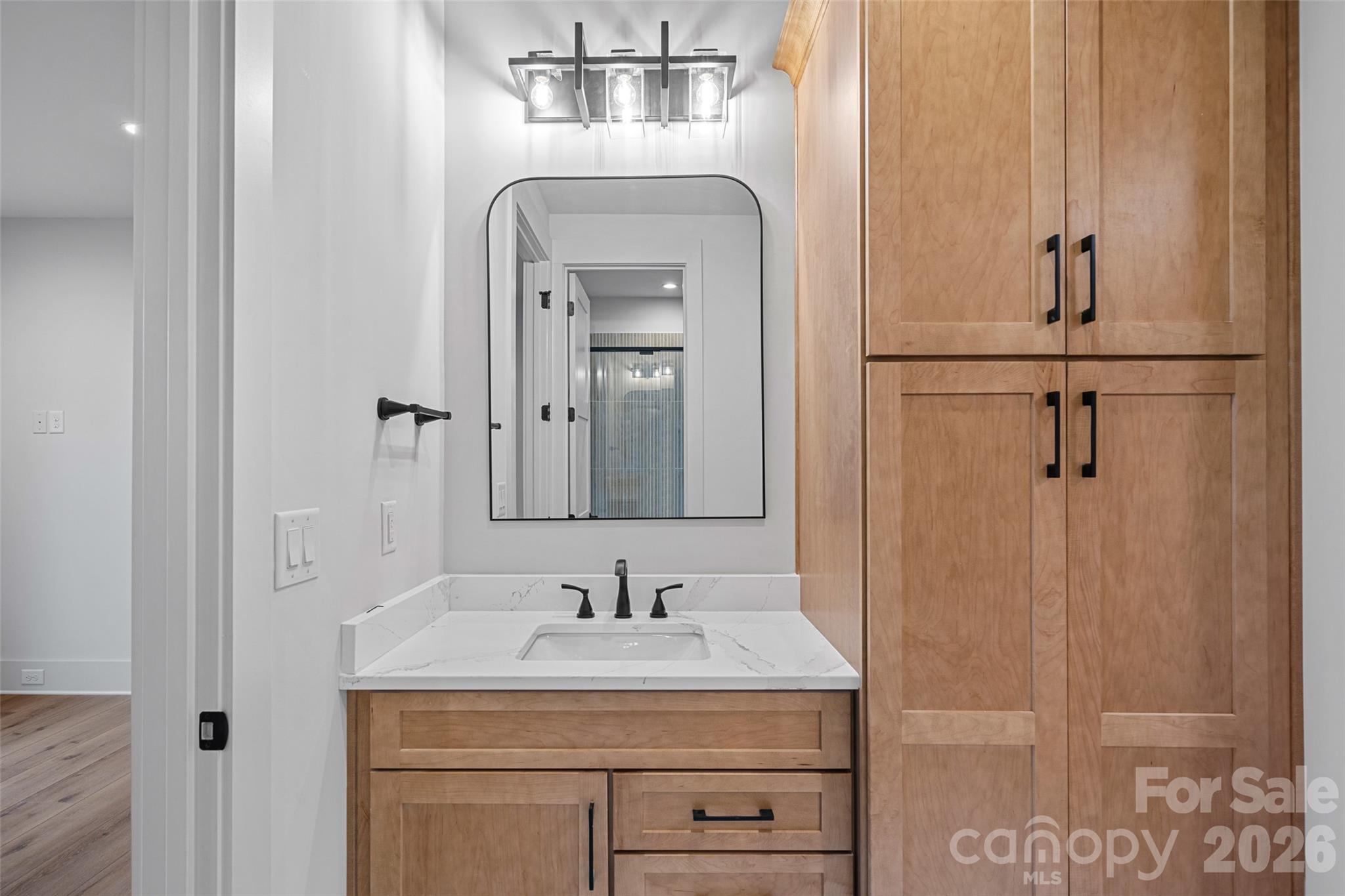515 Kemp Road Mooresville, NC 28117 - Photo 26 of 34 a bathroom with a granite countertop sink a mirror and a vanity
