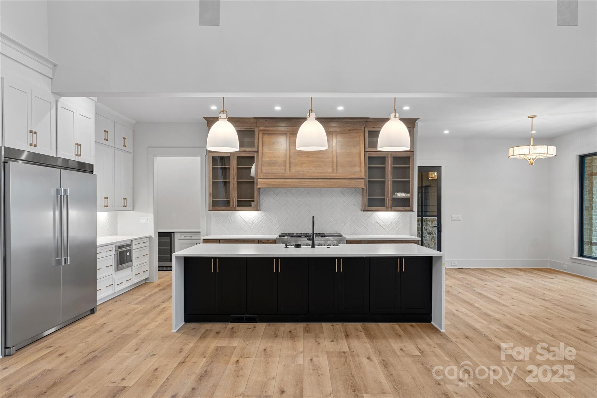 515 Kemp Road Mooresville, NC 28117 - Photo 6 of 24 a kitchen with a sink dishwasher a refrigerator and wooden floor