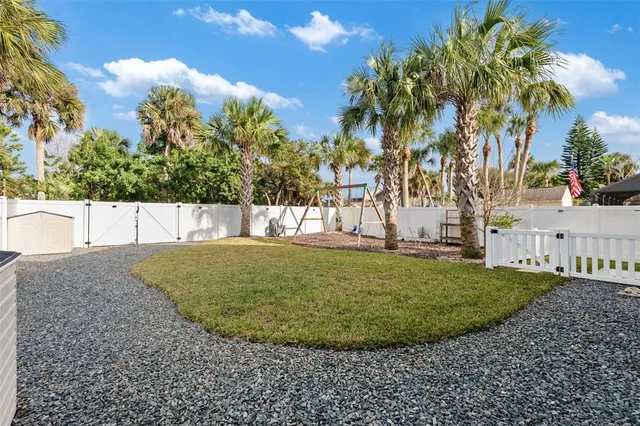 a view of a swimming pool with a lawn chairs under an umbrella