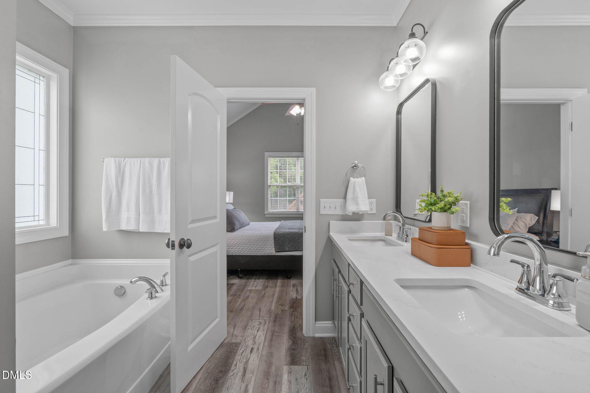 2450 Rolling Tracks Road Willow Spring, NC 27592 - Photo 33 of 64 a bathroom with a tub double vanity sink and mirror
