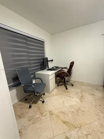 a work room with furniture and a rug