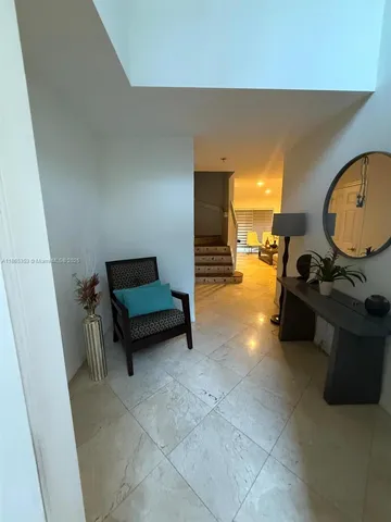 a living room with furniture and a mirror