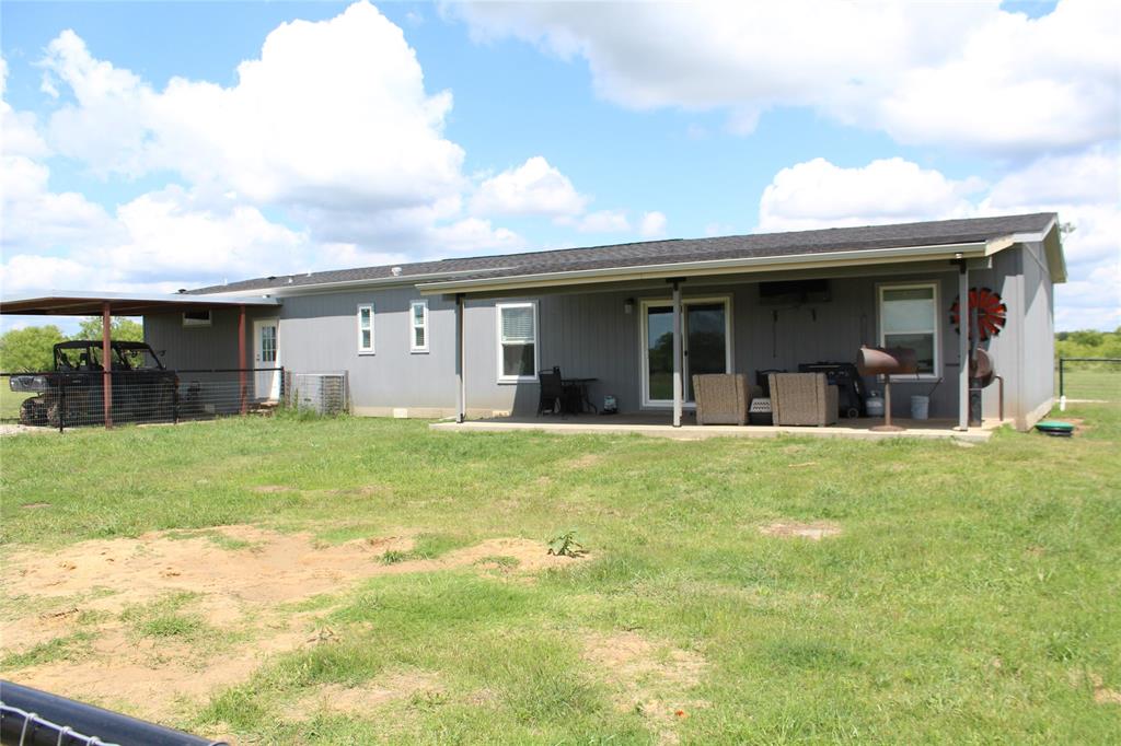 2077 A Shawver Road Perrin, TX 76486 - Photo 3 of 35 Gray siding exterior with a dark asphalt shingle roof