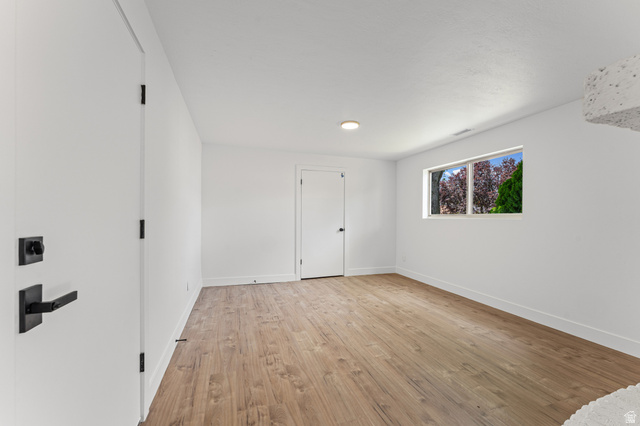 1898 West 600 South Provo, UT 84601 - Photo 25 of 32 Spacious room featuring wood-finish flooring, white walls, and a recessed ceiling light