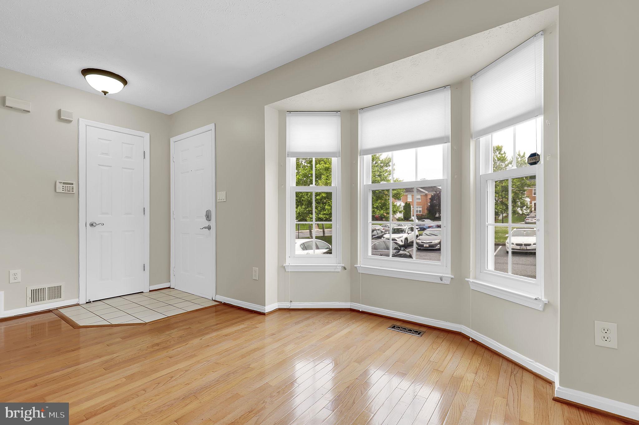 7150 Natures Road Columbia, MD 21046 - Photo 4 of 45 an empty room with wooden floor and windows