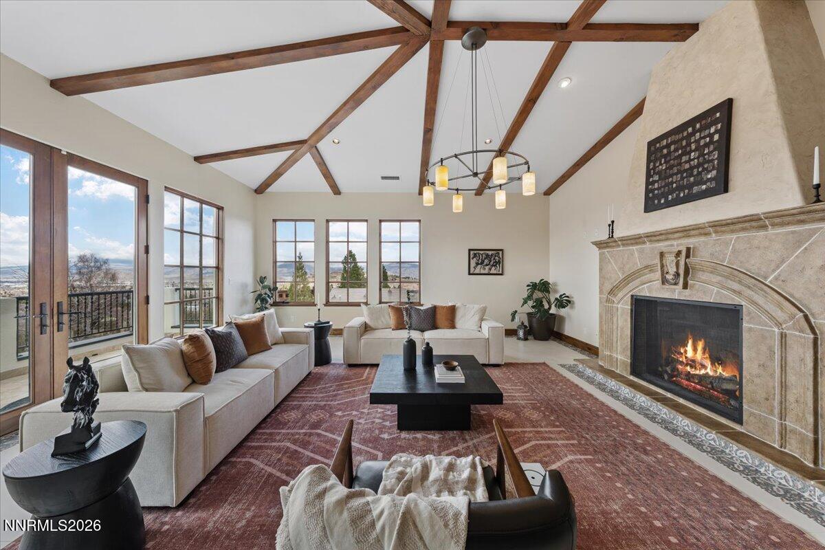 4400 Slide Mountain Circle Reno, NV 89511 - Photo 19 of 79 a living room with furniture a large window and a fireplace