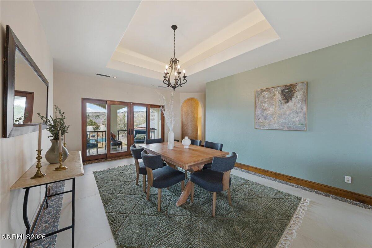4400 Slide Mountain Circle Reno, NV 89511 - Photo 19 of 93 a dining room with wooden floor and a chandelier