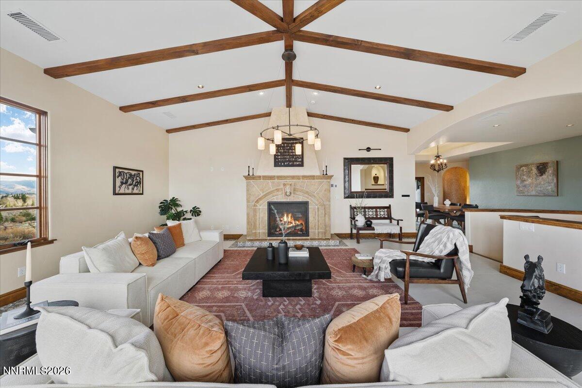 4400 Slide Mountain Circle Reno, NV 89511 - Photo 21 of 79 a living room with furniture a fireplace and a chandelier