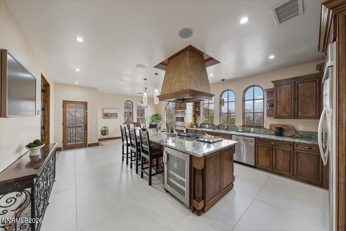 4400 Slide Mountain Circle Reno, NV 89511 - Photo 23 of 93 a kitchen with stainless steel appliances granite countertop a stove and a sink