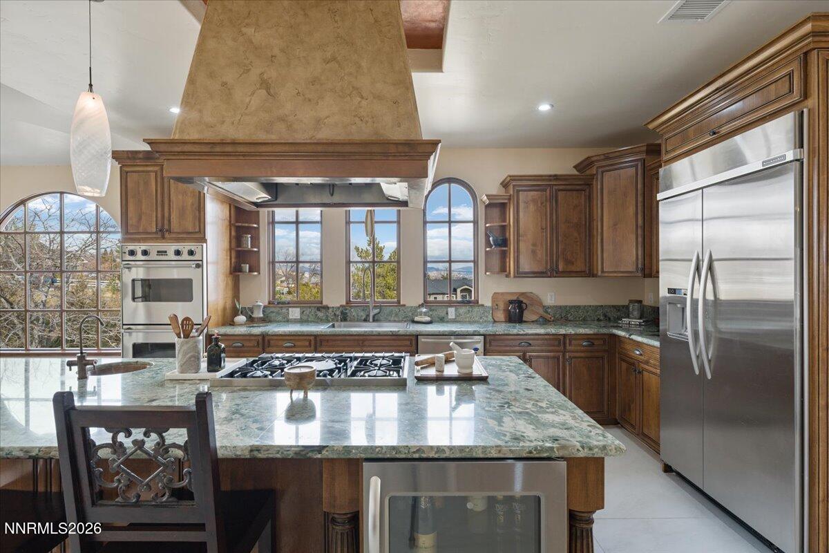 4400 Slide Mountain Circle Reno, NV 89511 - Photo 26 of 93 a kitchen with stainless steel appliances granite countertop a sink window and cabinets