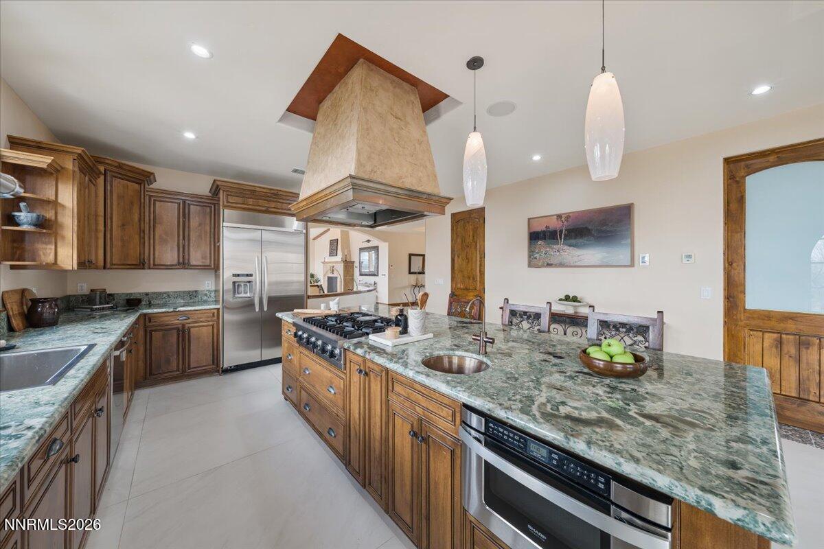 4400 Slide Mountain Circle Reno, NV 89511 - Photo 28 of 93 a kitchen with stainless steel appliances granite countertop a sink a stove and a wooden floors