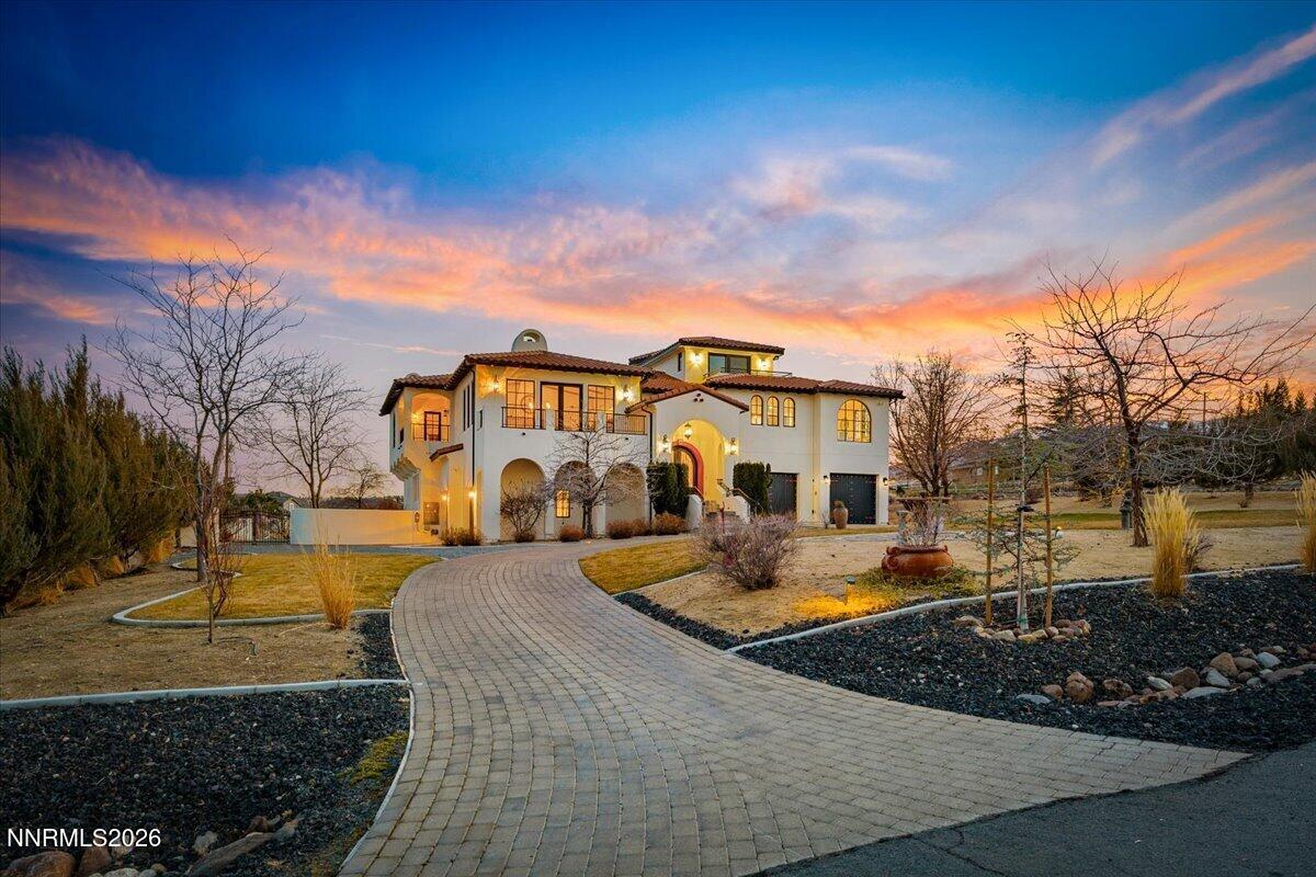 4400 Slide Mountain Circle Reno, NV 89511 - Photo 3 of 93 a view of a white house with a yard patio and fire pit