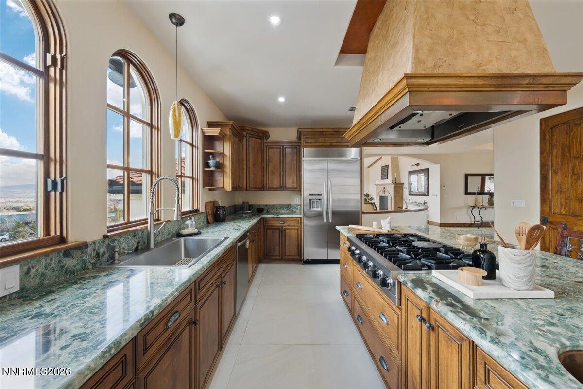 4400 Slide Mountain Circle Reno, NV 89511 - Photo 35 of 79 a kitchen with stainless steel appliances granite countertop a stove a sink and a refrigerator