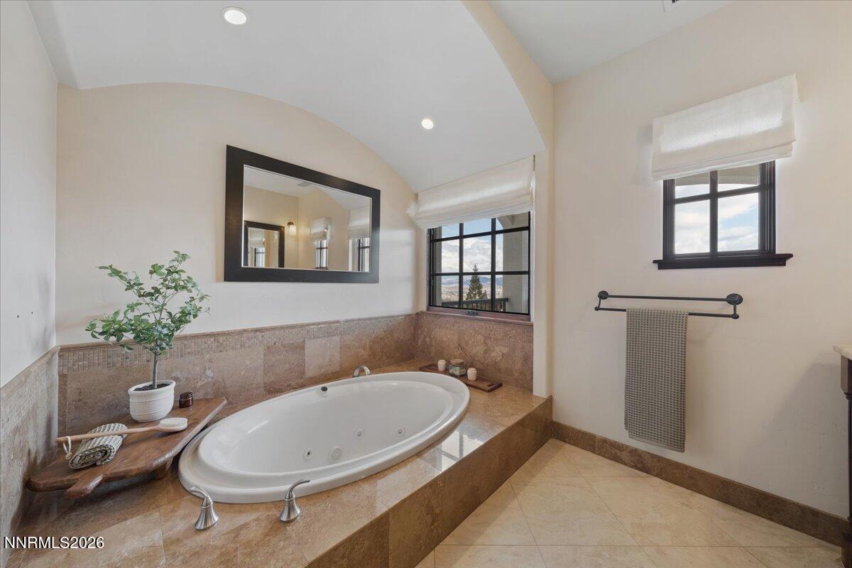 4400 Slide Mountain Circle Reno, NV 89511 - Photo 43 of 93 a bathroom with a granite countertop tub sink and mirror