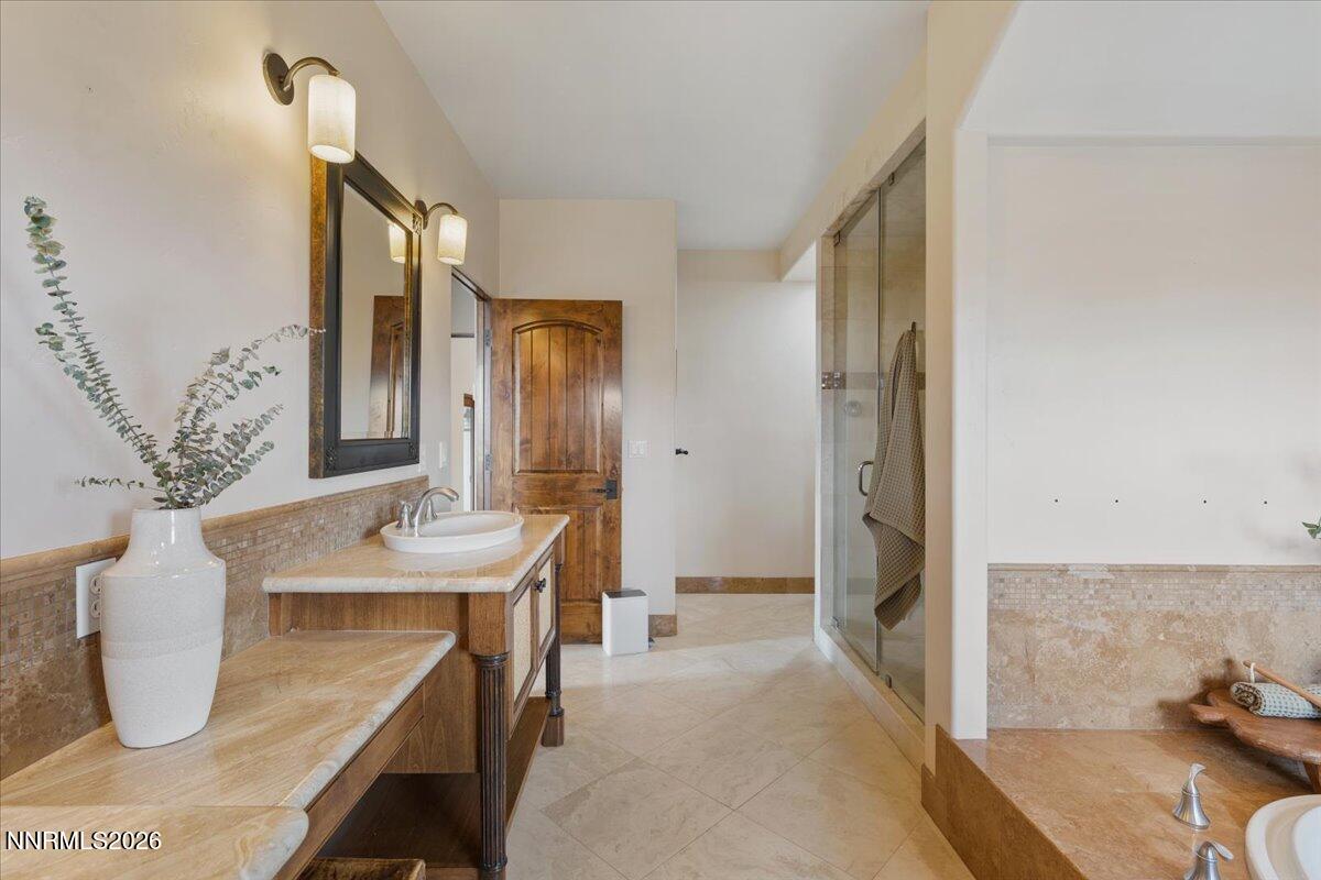 4400 Slide Mountain Circle Reno, NV 89511 - Photo 45 of 93 a bathroom with a granite countertop sink a mirror and shower