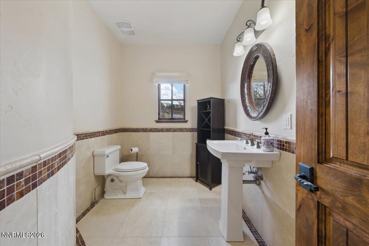 4400 Slide Mountain Circle Reno, NV 89511 - Photo 49 of 93 a bathroom with a toilet sink and mirror