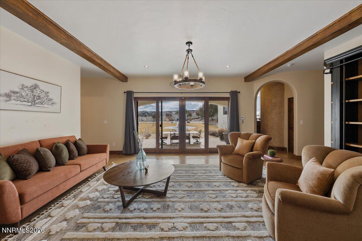 4400 Slide Mountain Circle Reno, NV 89511 - Photo 53 of 93 a living room with furniture a rug and a chandelier