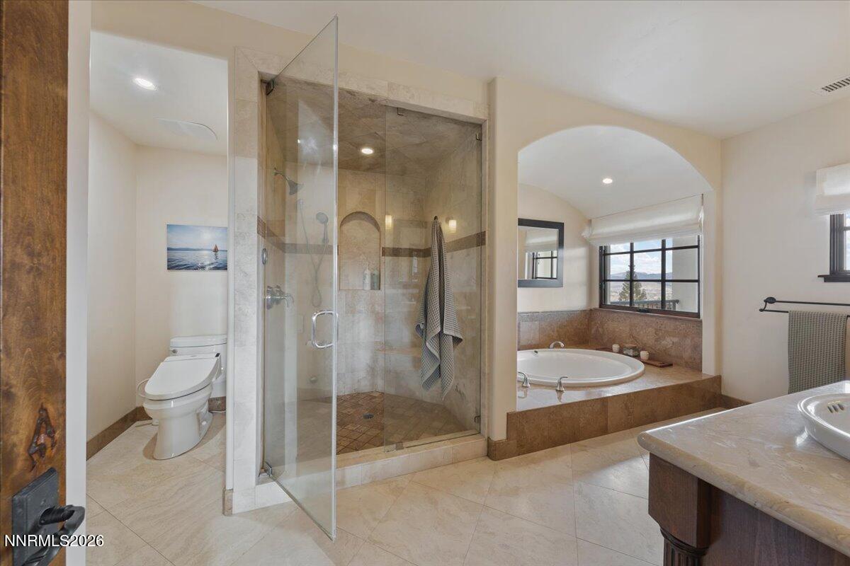 4400 Slide Mountain Circle Reno, NV 89511 - Photo 54 of 79 a bathroom with a tub shower vanity and sink