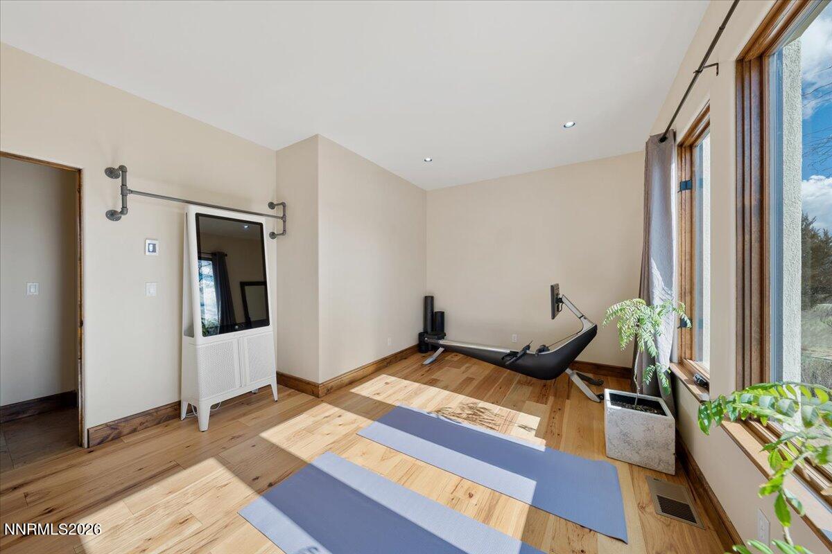 4400 Slide Mountain Circle Reno, NV 89511 - Photo 58 of 93 a bedroom with bed and wooden floor