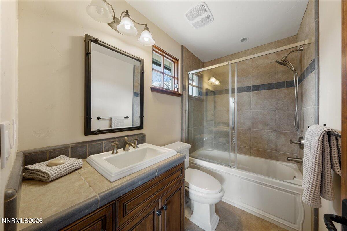 4400 Slide Mountain Circle Reno, NV 89511 - Photo 62 of 93 a bathroom with a granite countertop sink toilet and shower
