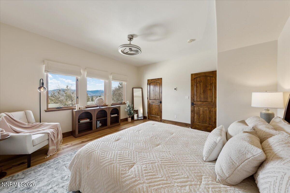 4400 Slide Mountain Circle Reno, NV 89511 - Photo 64 of 79 a bedroom with a bed large window and couch