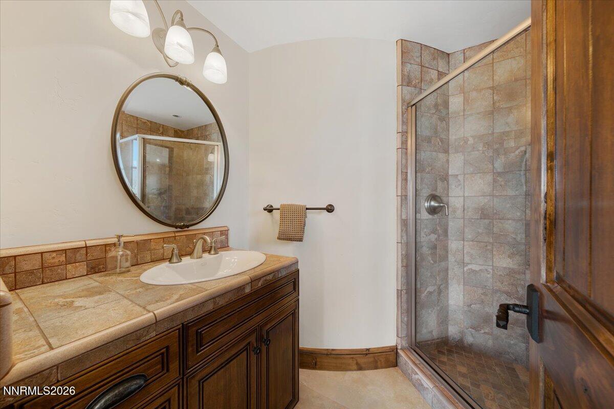 4400 Slide Mountain Circle Reno, NV 89511 - Photo 67 of 93 a bathroom with a sink and a mirror