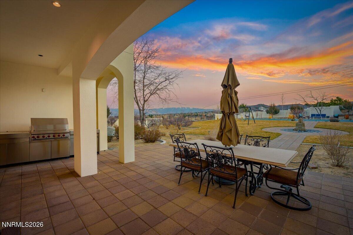 4400 Slide Mountain Circle Reno, NV 89511 - Photo 74 of 93 a view of a outdoor kitchen with a table and chairs