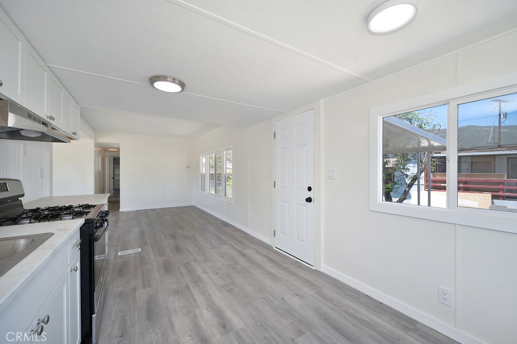 26455 Paradise Valley Road, Unit 86 Warner Springs, CA 92086 - Photo 11 of 34 a view of a kitchen with a sink wooden floor and windows