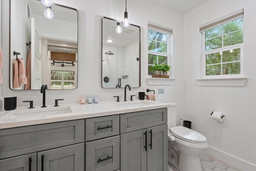 15988 Wortham Bend Road China Spring, TX 76633 - Photo 20 of 40 Dual vanity with gray shaker cabinetry and white countertops