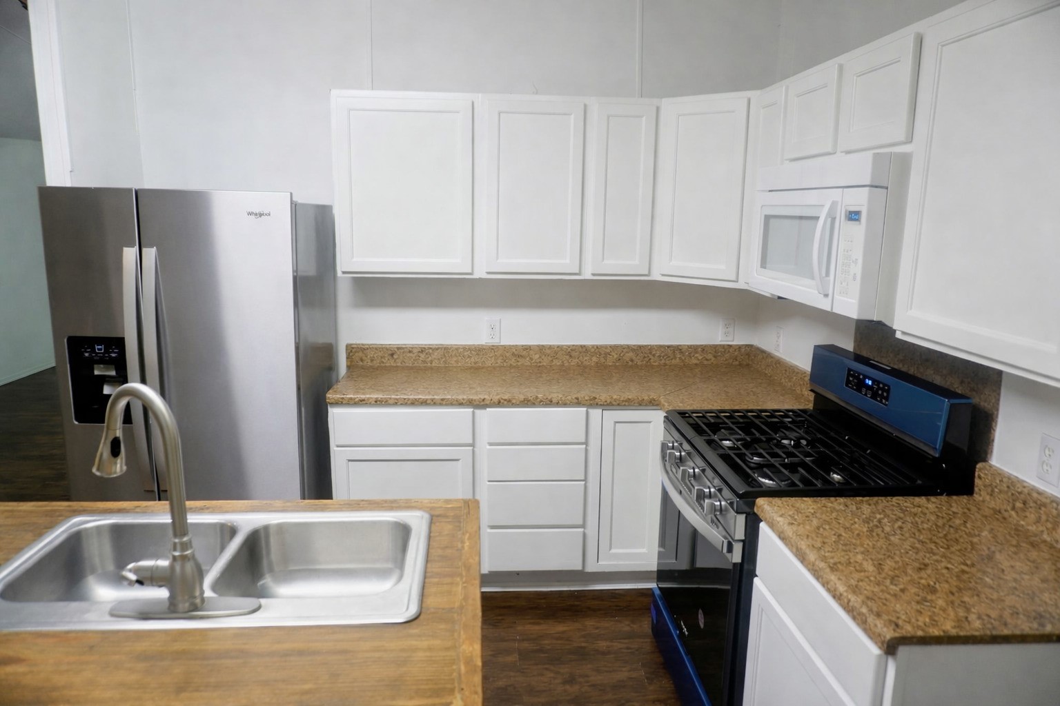 26331 Pinion Creek Road Magnolia, TX 77355 - Photo 4 of 14 a kitchen with granite countertop a sink stainless steel appliances and cabinets