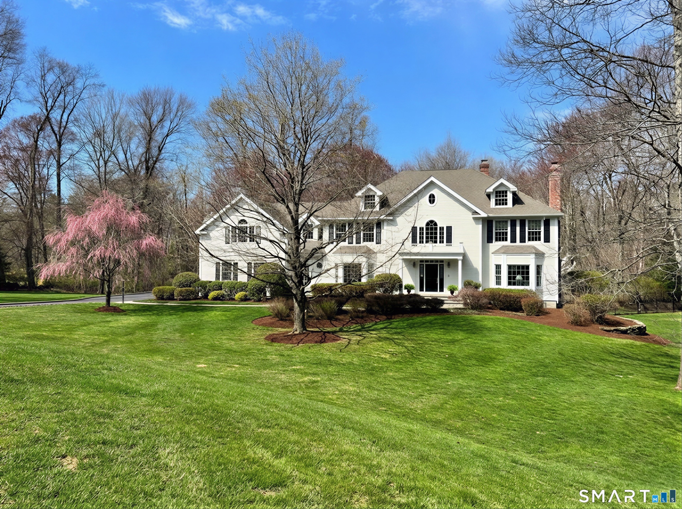8 Maplewood Lane Wilton, CT 06897 - Photo 1 of 40 a front view of a house with a garden