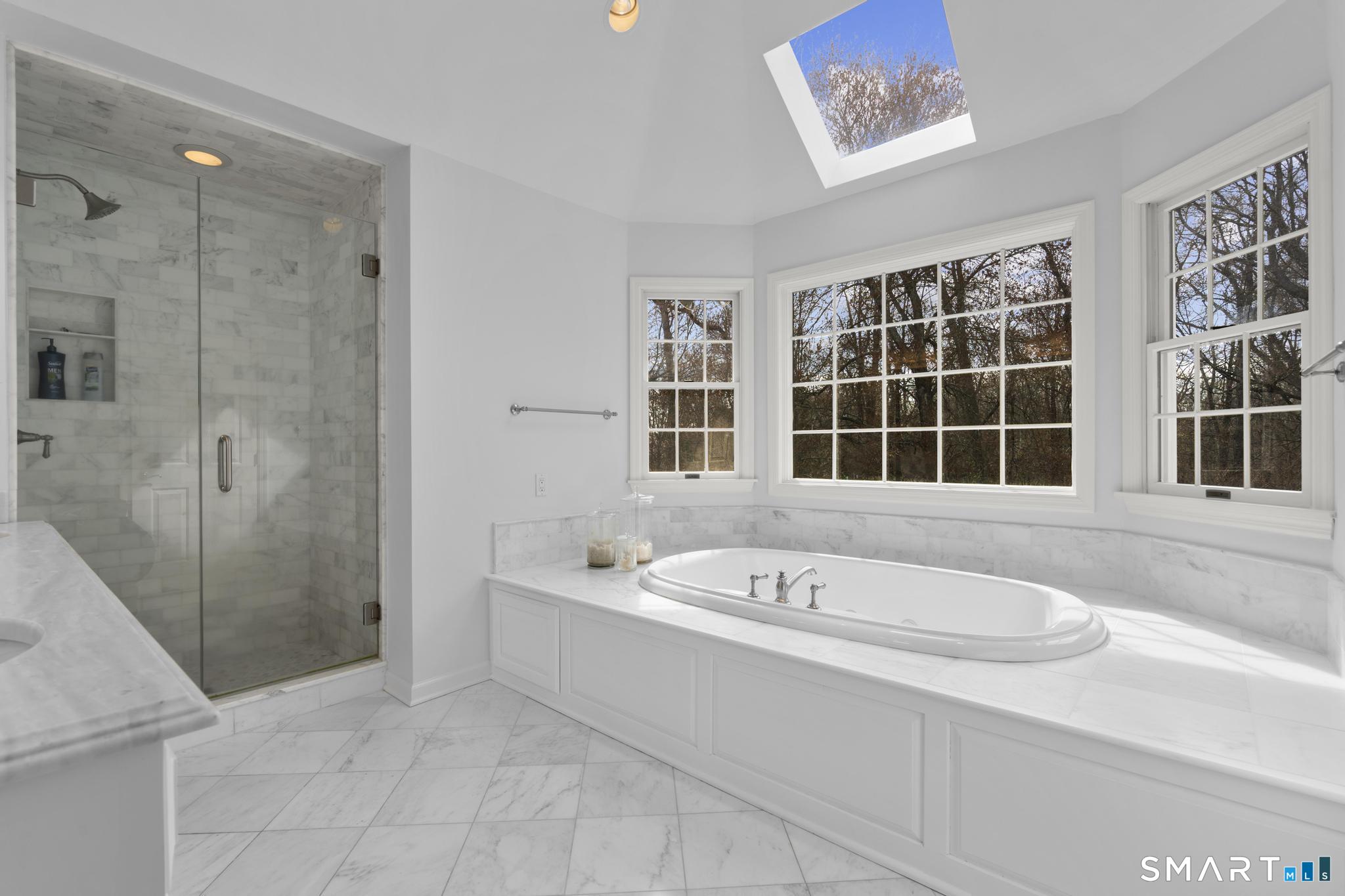8 Maplewood Lane Wilton, CT 06897 - Photo 19 of 40 a bathroom with a tub a sink and a window