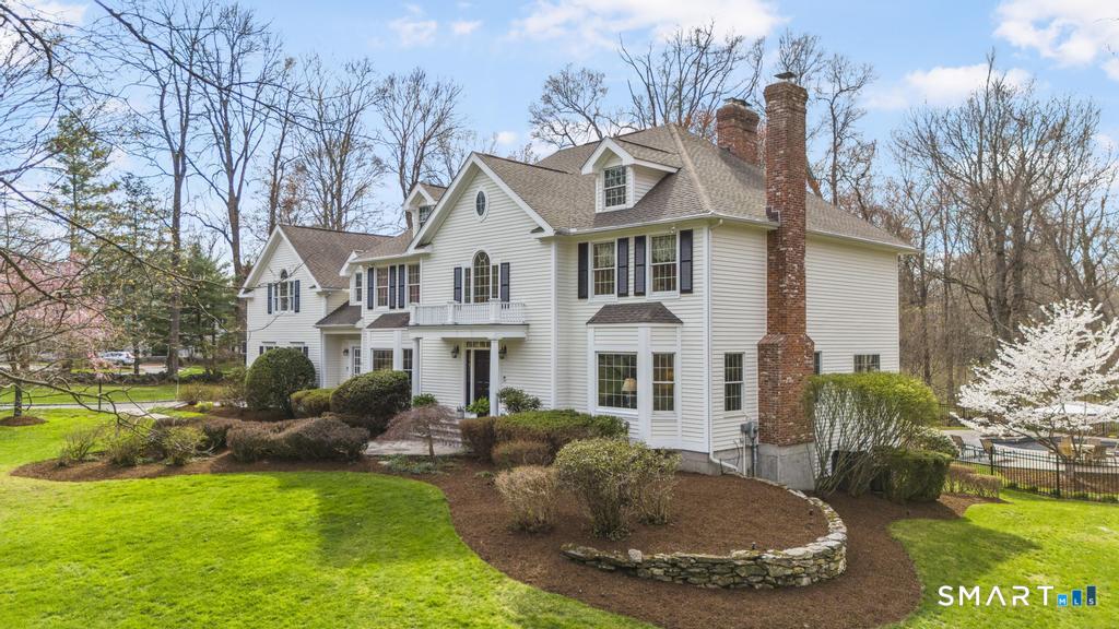 8 Maplewood Lane Wilton, CT 06897 - Photo 2 of 40 a view of a white house with a big yard and potted plants