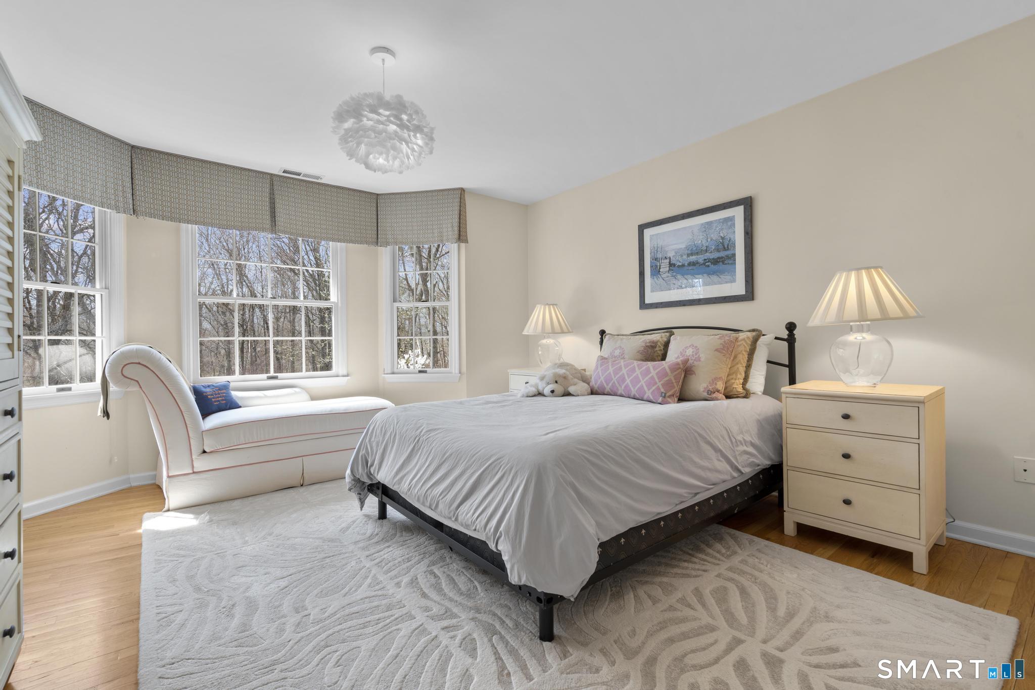 8 Maplewood Lane Wilton, CT 06897 - Photo 21 of 40 a bedroom with a large bed and a couch